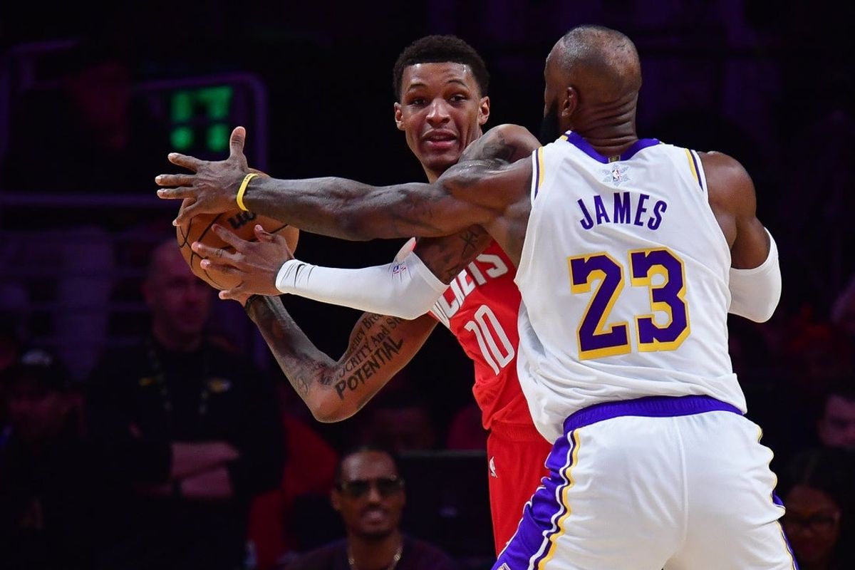 Dec 25, 2025; Los Angeles, California, USA; Houston Rockets forward Jabari Smith Jr. (10) moves the ball against Los Angeles Lakers forward LeBron James (23) during the first half at Crypto.com Arena. Mandatory Credit: Gary A. Vasquez-Imagn Images