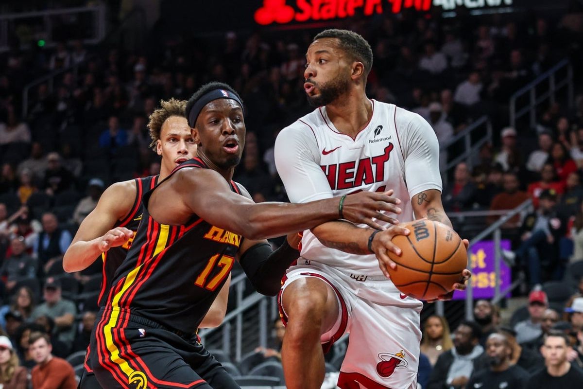 Dec 26, 2025; Atlanta, Georgia, USA; Miami Heat guard Norman Powell (24) makes a pass against Atlanta Hawks forward Onyeka Okongwu (17) during the first quarter at State Farm Arena. Mandatory Credit: Jordan Godfree-Imagn Images