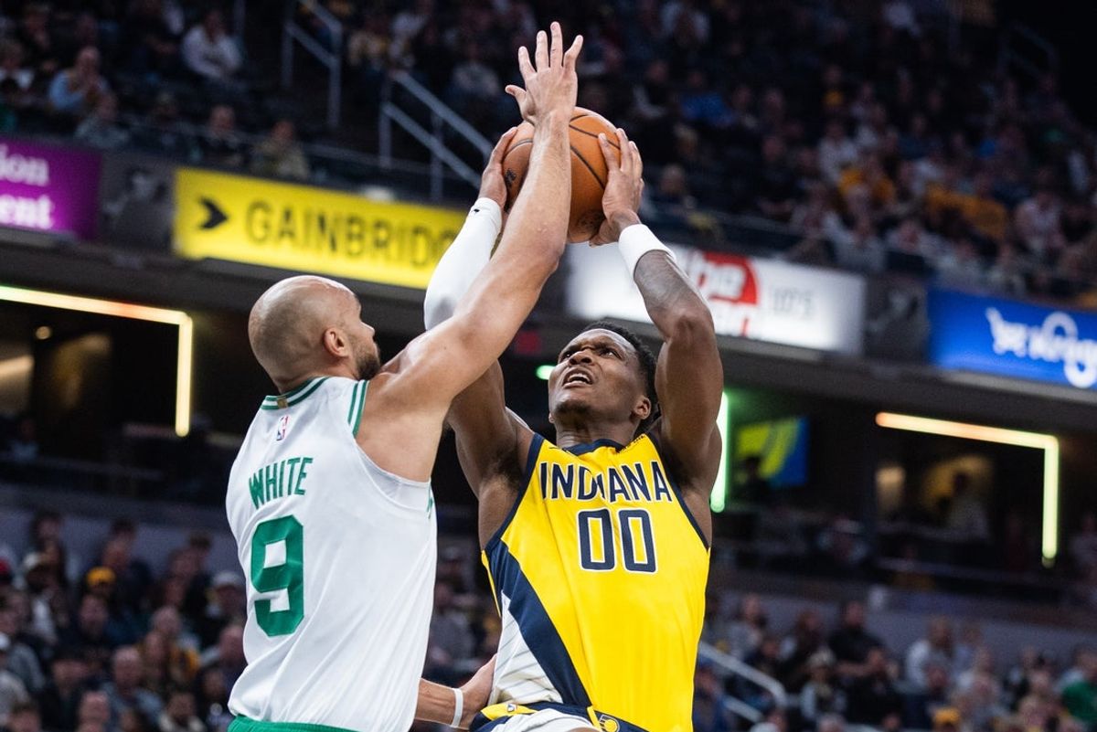 Dec 26, 2025; Indianapolis, Indiana, USA; Indiana Pacers guard/forward Bennedict Mathurin (00) shoots the ball while   Boston Celtics guard Derrick White (9) defends in the first half at Gainbridge Fieldhouse. Mandatory Credit: Trevor Ruszkowski-Imagn Images