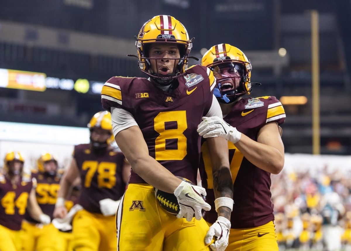 Dec 26, 2025; Phoenix, AZ, USA; Minnesota Gophers wide receiver Jalen Smith (8) celebrates with teammate Logan Loya (17) after catching the game winning touchdown pass against the New Mexico Lobos during overtime of the Rate Bowl at Chase Field. Mandatory Credit: Mark J. Rebilas-Imagn Images