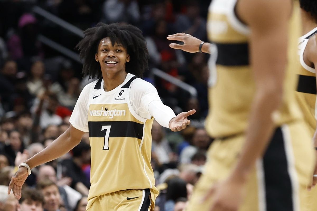 Dec 26, 2025; Washington, District of Columbia, USA;  Washington Wizards guard Bub Carrington (7) celebrates with Washington Wizards forward Marvin Bagley III (35) after a called timeout by the Toronto Raptors in the second halfat Capital One Arena. Mandatory Credit: Geoff Burke-Imagn Images