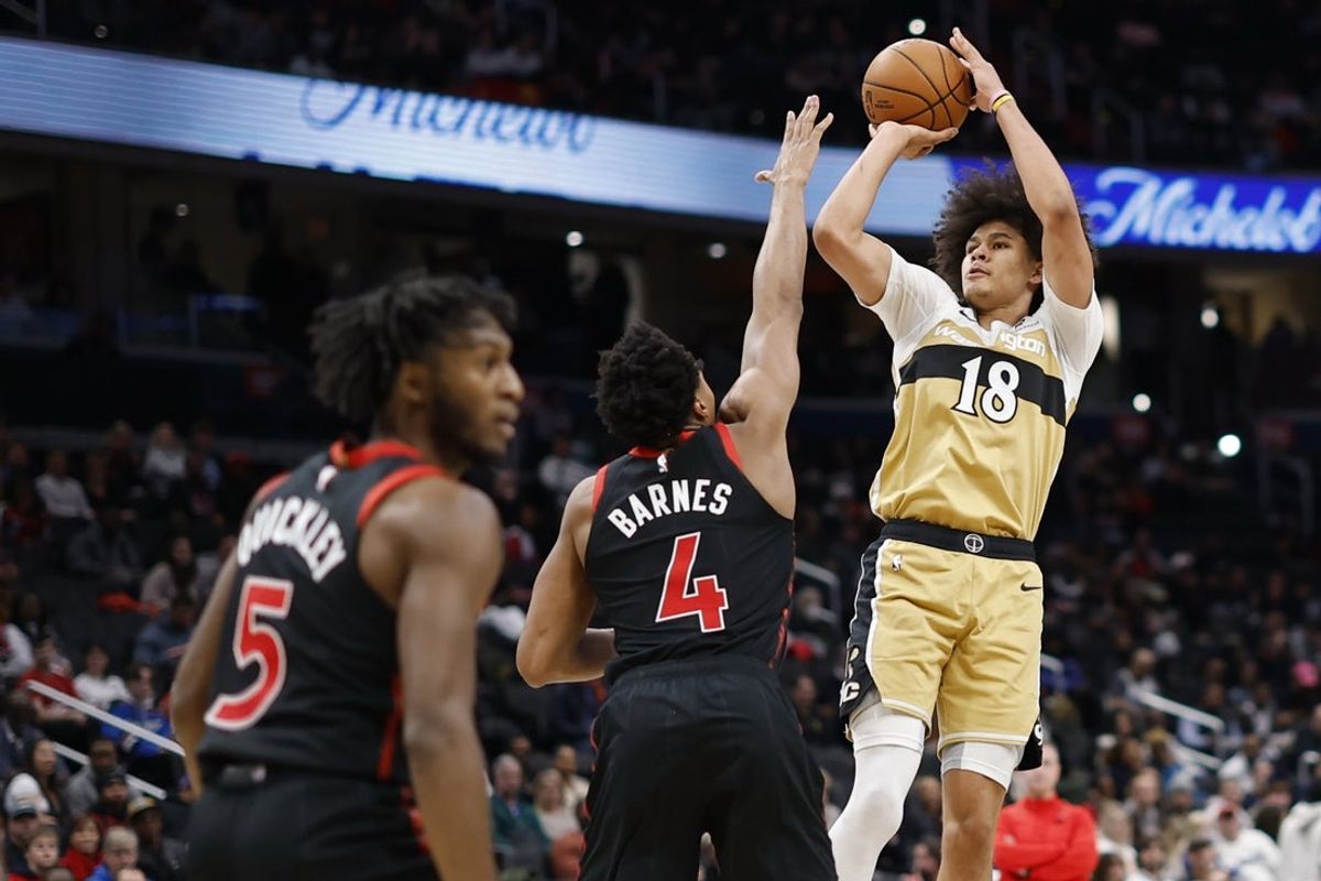 Dec 26, 2025; Washington, District of Columbia, USA; Washington Wizards forward Kyshawn George (18) shoots the ball over Toronto Raptors forward Scottie Barnes (4) in the second half at Capital One Arena. Mandatory Credit: Geoff Burke-Imagn Images