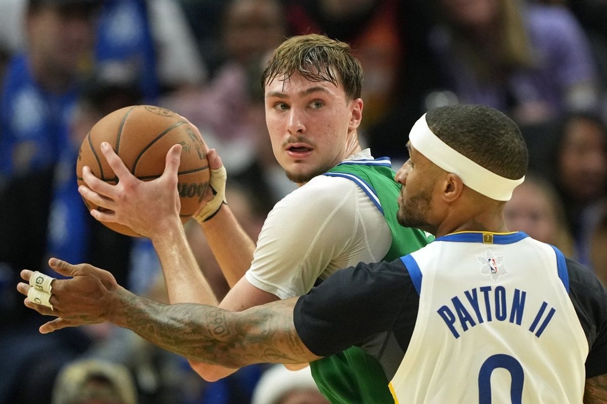 Dec 25, 2025; San Francisco, California, USA; Dallas Mavericks forward Cooper Flagg (left) handles the ball against Golden State Warriors guard Gary Payton II (0) during the third quarter at Chase Center. Mandatory Credit: Darren Yamashita-Imagn Images