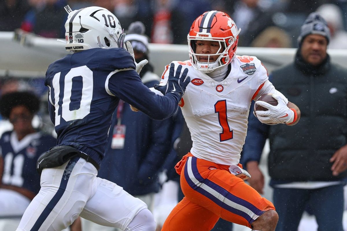 Dec 27, 2025; Bronx, NY, USA; Clemson Tigers wide receiver T.J. Moore (1) fights for yards against Penn State Nittany Lions safety Dejuan Lane (10) during the first half of the 2025 Pinstripe Bowl at Yankee Stadium. Mandatory Credit: Vincent Carchietta-Imagn Images