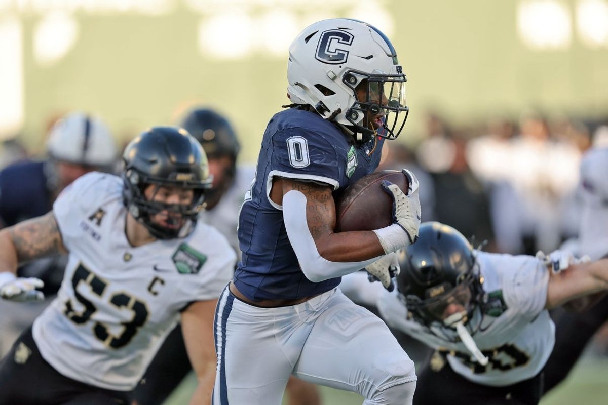 Dec 27, 2025; Boston, MA, USA; UConn Huskies running back Cam Edwards (0) runs the ball against the Army Black Knights during the first half of the Wasabi Fenway Bowl at Fenway Park. Mandatory Credit: Danny Wild-Imagn Images