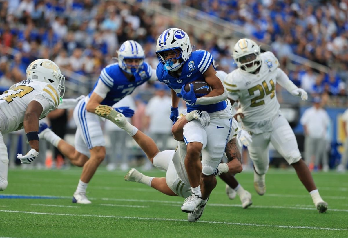 Dec 27, 2025; Orlando, FL, USA; BYU Cougars running back Jovesa Damuni (28) runs with the ball against the Georgia Tech Yellow Jackets  during the first half at Camping World Stadium. Mandatory Credit: Kim Klement Neitzel-Imagn Images