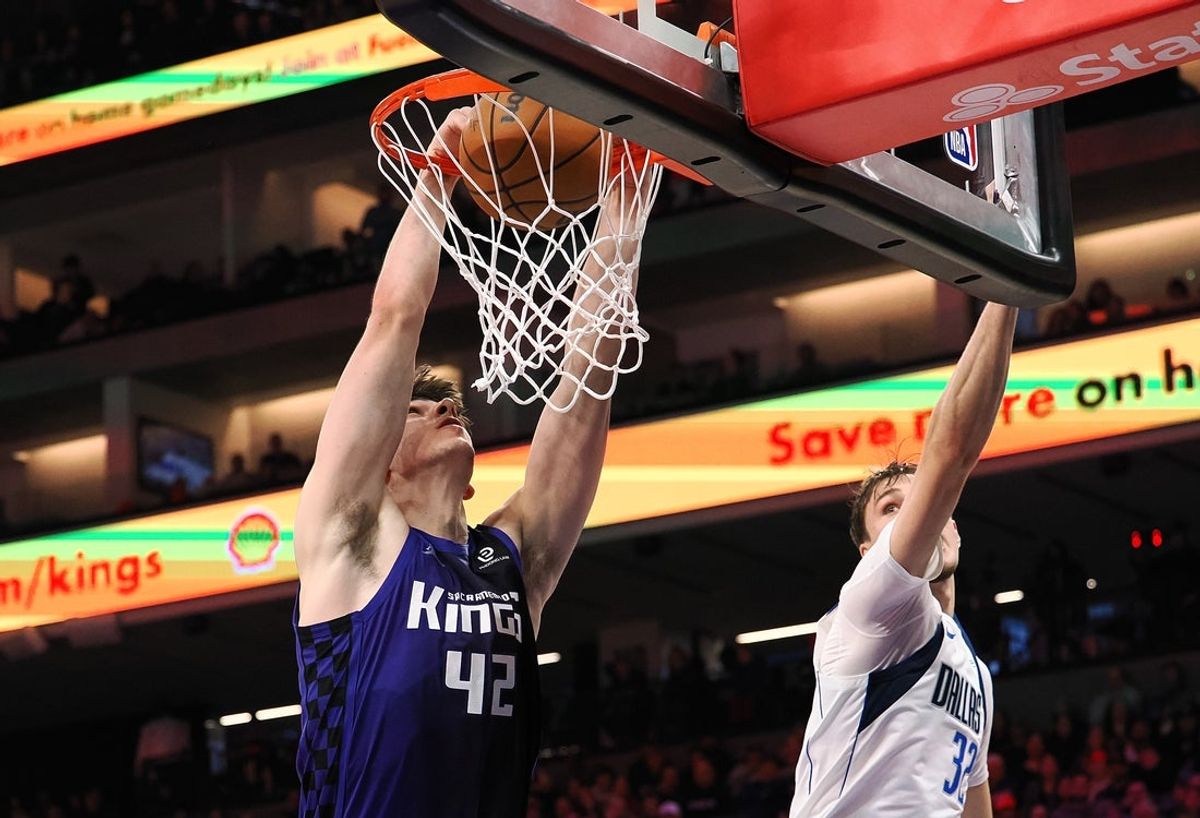 Dec 27, 2025; Sacramento, California, USA; Sacramento Kings center Maxime Raynaud (42) dunks the ball against Dallas Mavericks forward/guard Cooper Glagg (32) during the fourth quarter at Golden 1 Center. Mandatory Credit: Kelley L Cox-Imagn Images