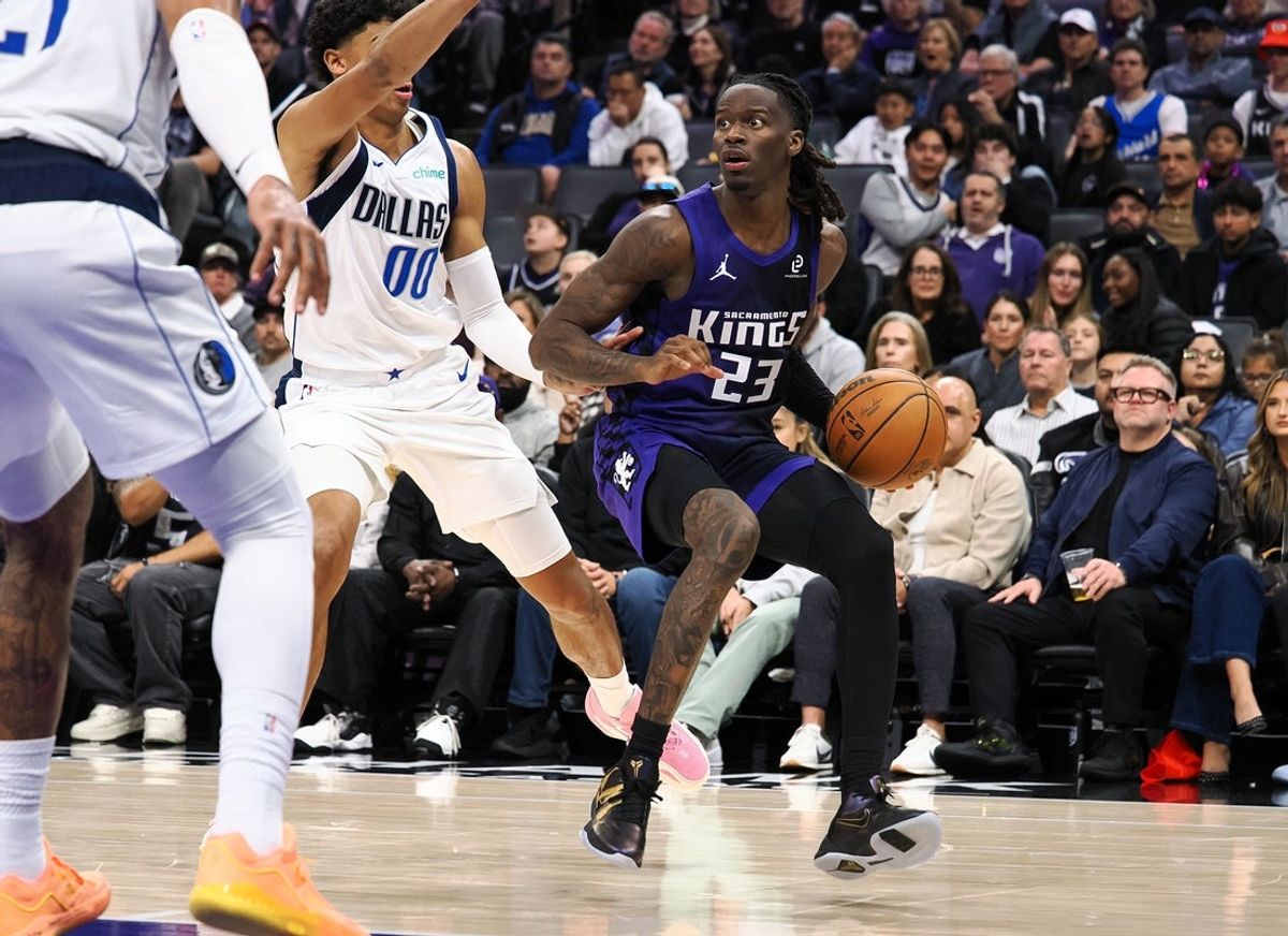 Dec 27, 2025; Sacramento, California, USA; Sacramento Kings guard Keon Ellis (23) controls the ball against Dallas Mavericks guard Max Christie (00) during the fourth quarter at Golden 1 Center. Mandatory Credit: Kelley L Cox-Imagn Images