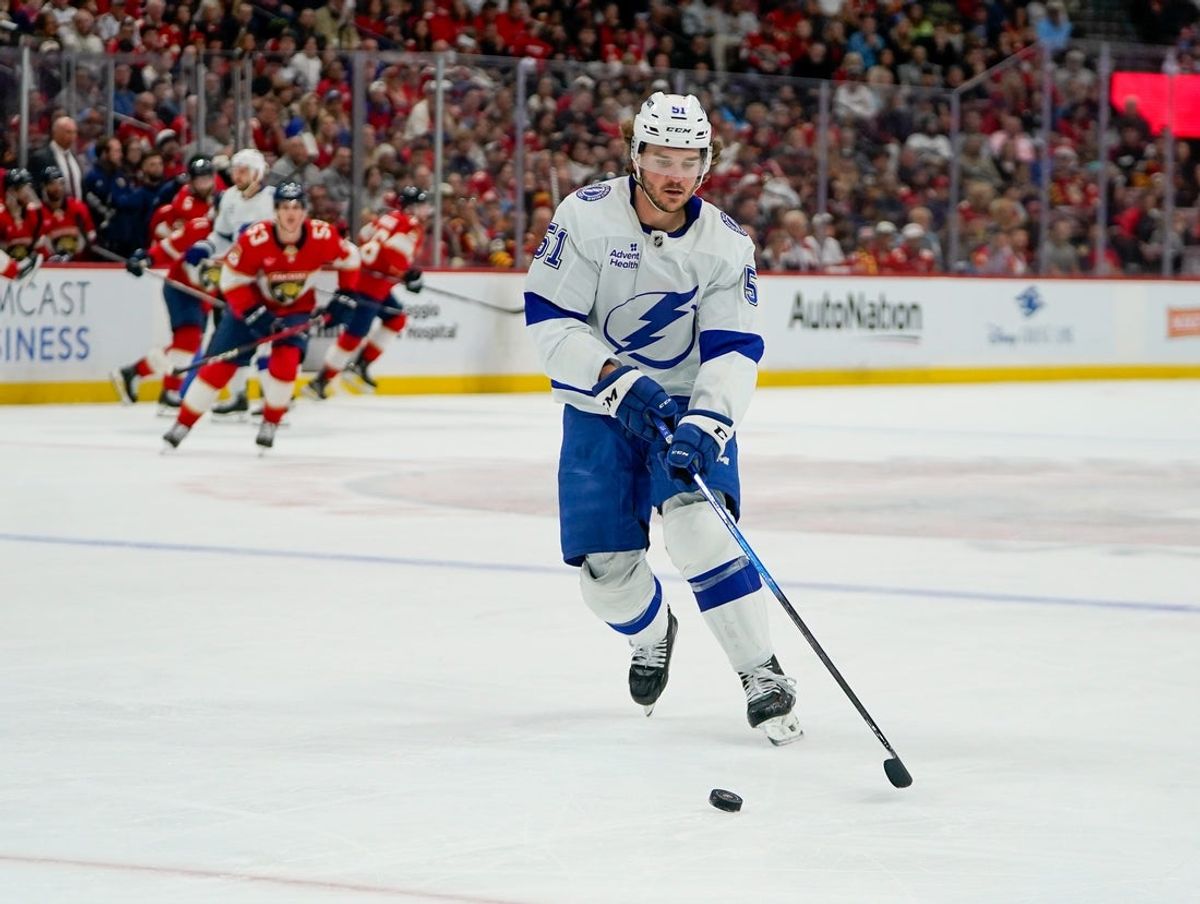 Dec 27, 2025; Sunrise, Florida, USA; Tampa Bay Lightning defenseman Charle-Edouard D'Astous (51) moves the puck against the Florida Panthers during the first period at Amerant Bank Arena. Mandatory Credit: Jeff Romance-Imagn Images