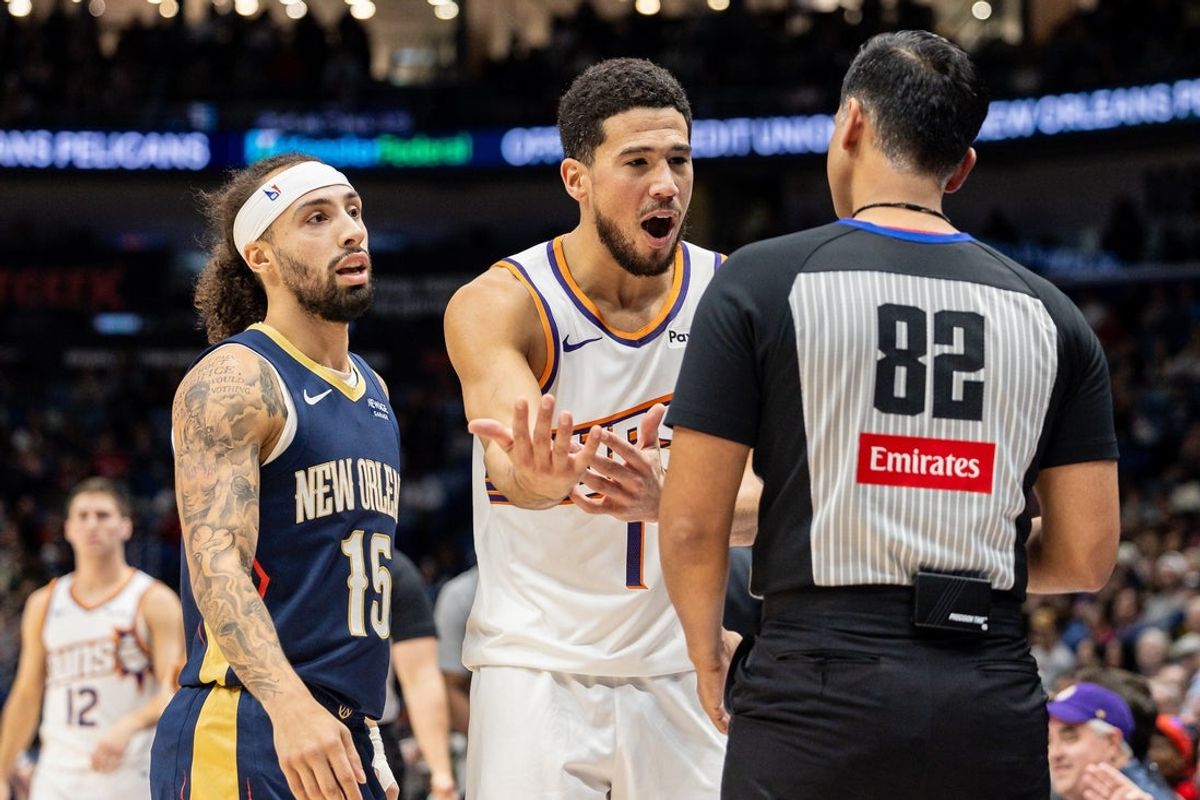 Dec 27, 2025; New Orleans, Louisiana, USA;  Phoenix Suns guard Devin Booker (1) pleads with referee Suyash Mehta (82) about a play against New Orleans Pelicans guard Jose Alvarado (15) during the first half at Smoothie King Center. Mandatory Credit: Stephen Lew-Imagn Images