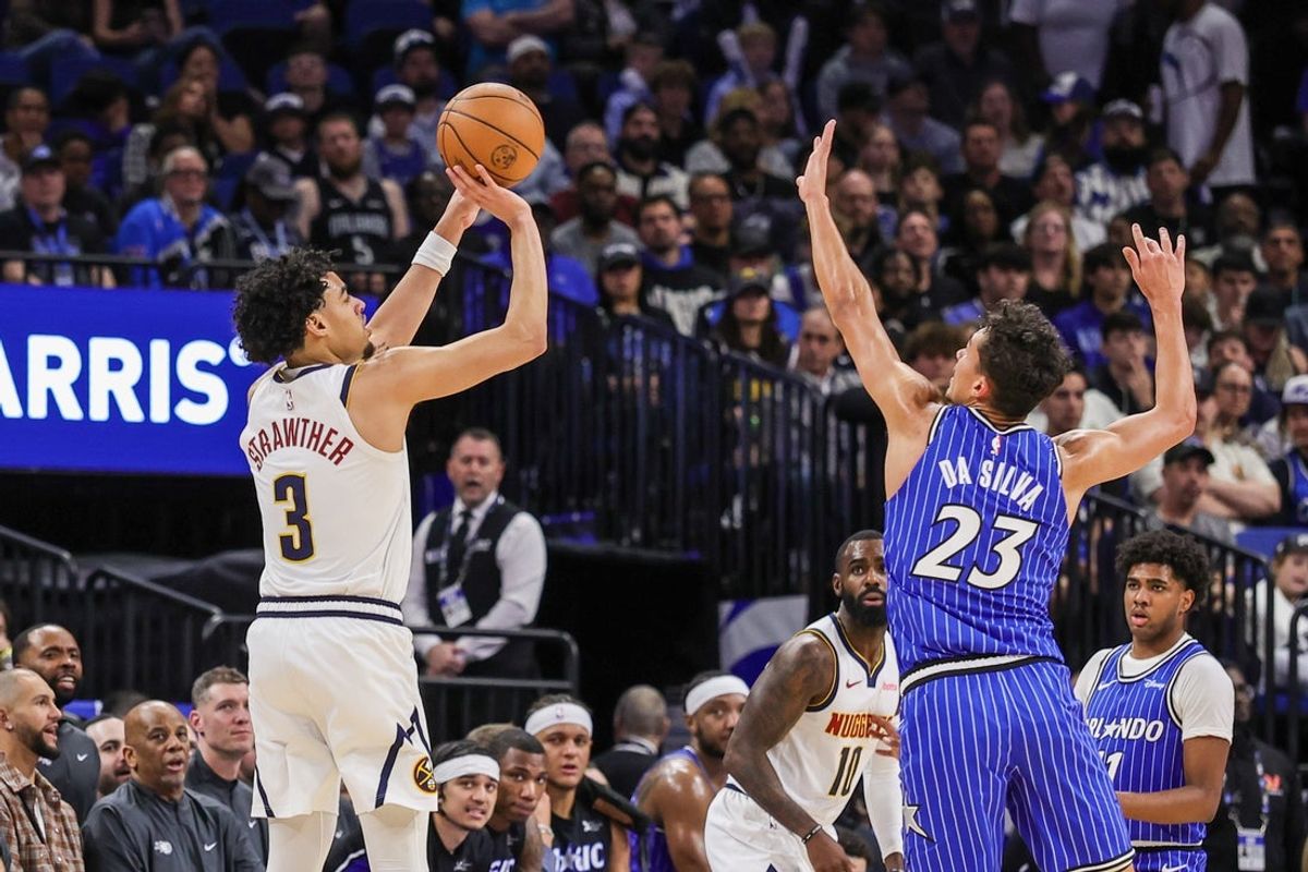 Dec 27, 2025; Orlando, Florida, USA; Denver Nuggets guard Julian Strawther (3) shoots a three point basket against Orlando Magic forward Tristan da Silva (23) during the second quarter at Kia Center. Mandatory Credit: Mike Watters-Imagn Images