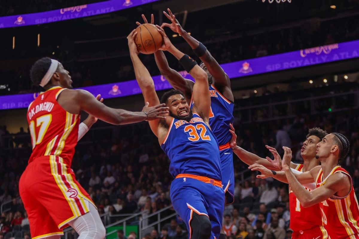 Dec 27, 2025; Atlanta, Georgia, USA; New York Knicks center Karl-Anthony Towns (32) grabs a rebound against the Atlanta Hawks in the first quarter at State Farm Arena. Mandatory Credit: Brett Davis-Imagn Images