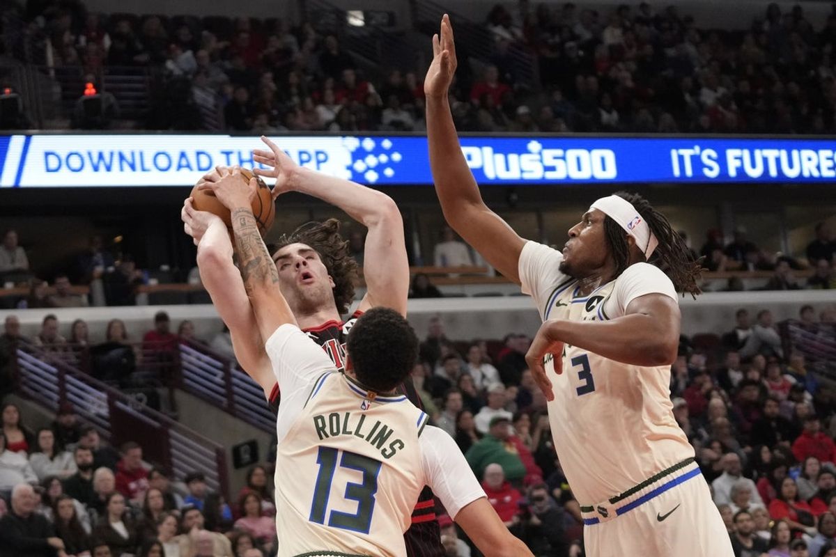 Dec 27, 2025; Chicago, Illinois, USA; Milwaukee Bucks center Myles Turner (3) guard Ryan Rollins (13) defend Chicago Bulls guard Josh Giddey (3) during the first half at United Center. Mandatory Credit: David Banks-Imagn Images