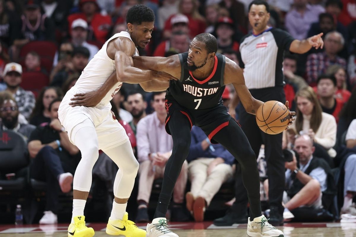Dec 27, 2025; Houston, Texas, USA;  Cleveland Cavaliers forward De'Andre Hunter (12) defends against Houston Rockets forward Kevin Durant (7) during the first quarter at Toyota Center. Mandatory Credit: Troy Taormina-Imagn Images