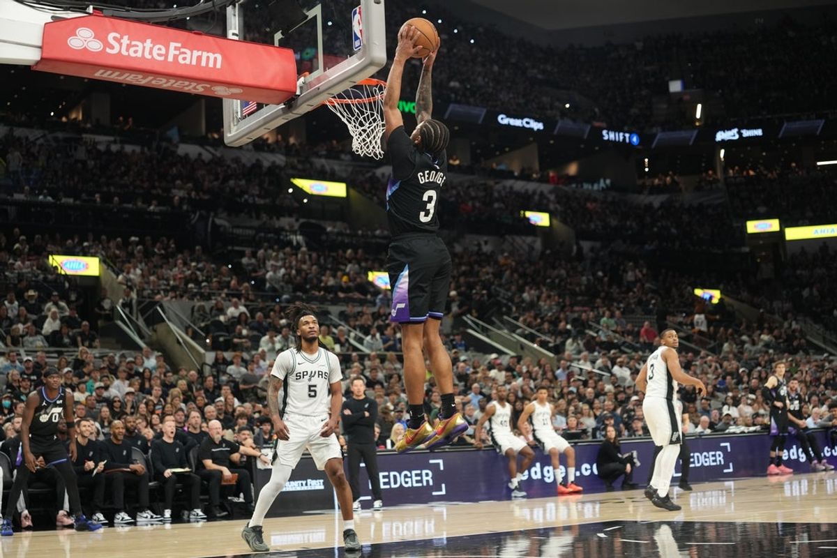 Dec 27, 2025; San Antonio, Texas, USA; Utah Jazz guard Keyonte George (3) dunks ahead of San Antonio Spurs guard Stephon Castle (5) during the first half at Frost Bank Center. Mandatory Credit: Scott Wachter-Imagn Images
