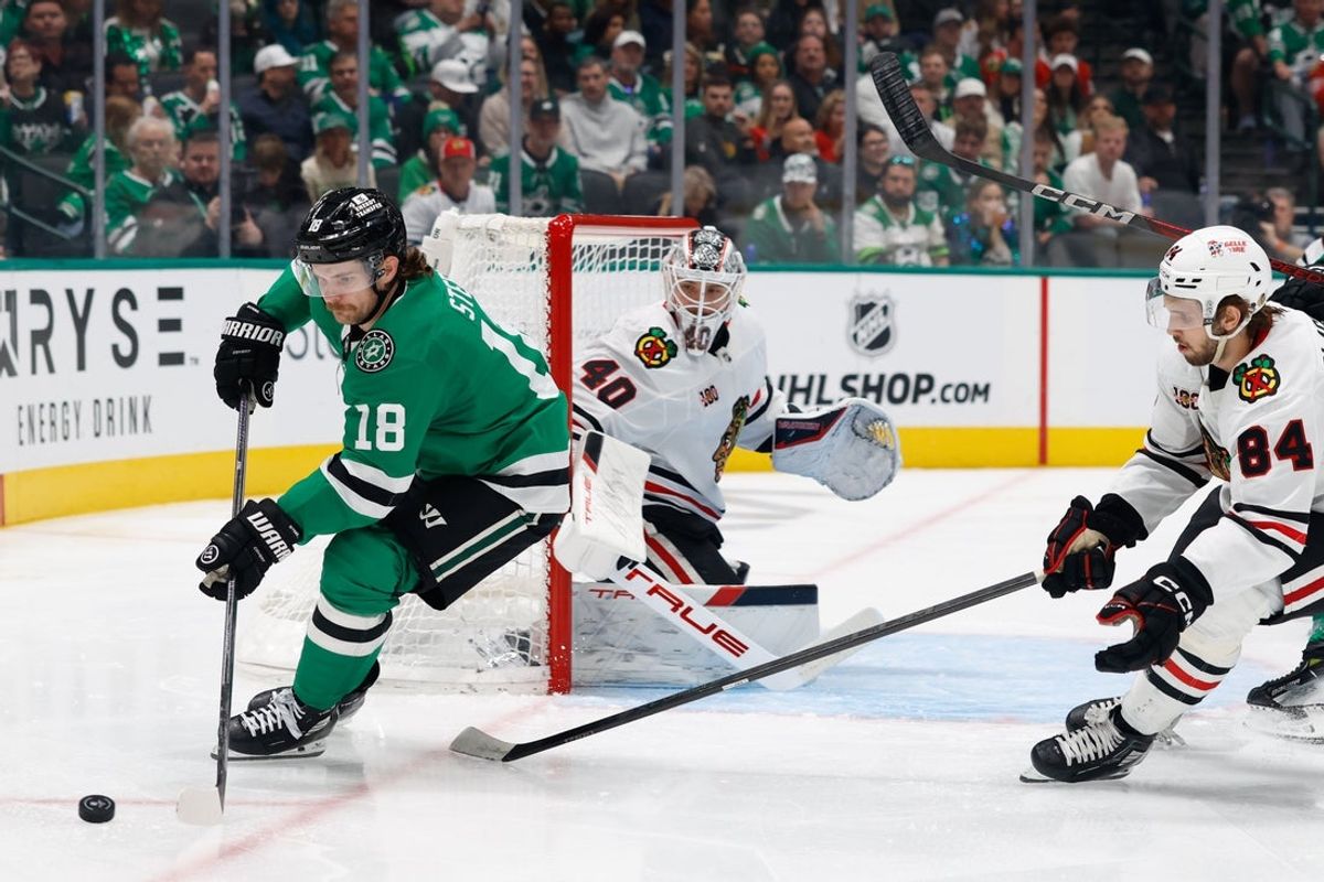 Dec 27, 2025; Dallas, Texas, USA; Dallas Stars center Sam Steel (18) skates with the puck against Chicago Blackhawks left wing Landon Slaggert (84) during the second period at American Airlines Center. Mandatory Credit: Chris Jones-Imagn Images