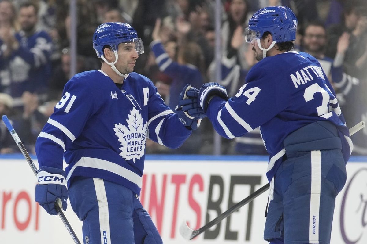 Dec 27, 2025; Toronto, Ontario, CAN; Toronto Maple Leafs forward Auston Matthews (34) congratulates forward John Tavares (91) for scoring an empty net goal against the Ottawa Senators during the third period at Scotiabank Arena. Mandatory Credit: John E. Sokolowski-Imagn Images