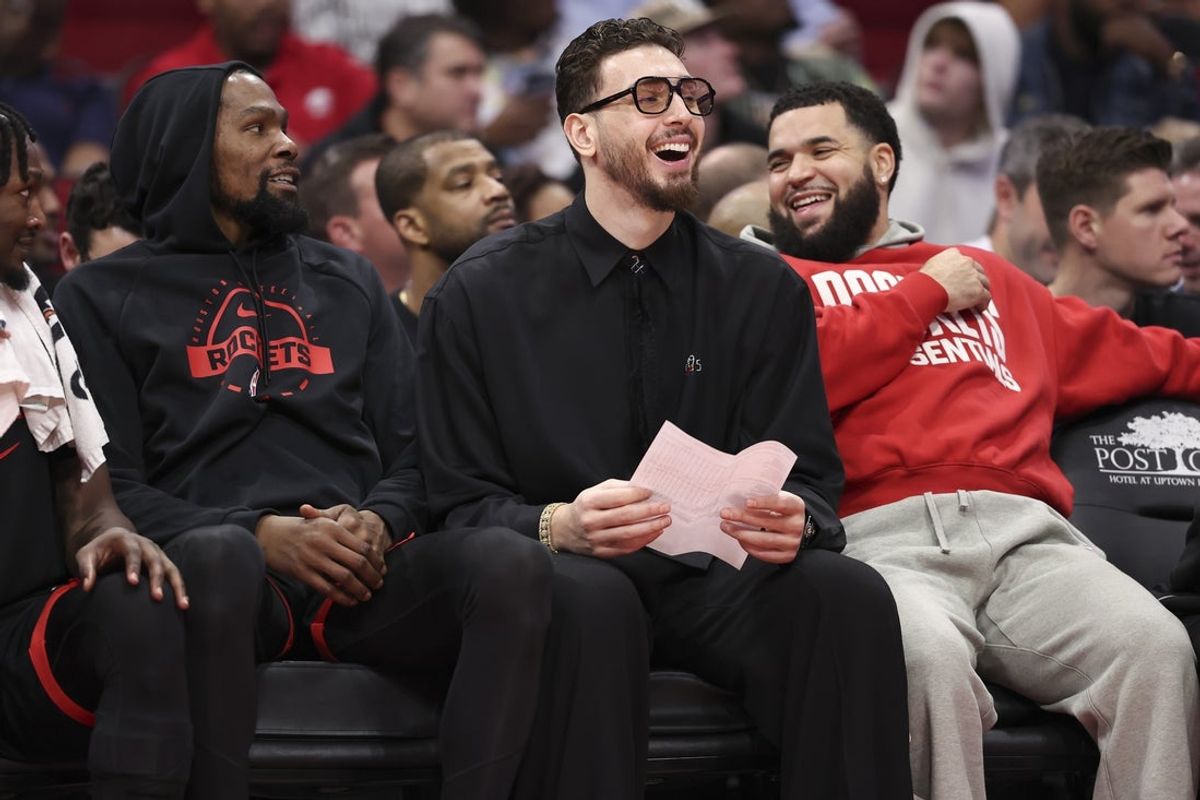 Dec 27, 2025; Houston, Texas, USA;  Houston Rockets center Alperen Sengun (middle) laughs on the bench with forward Kevin Durant (left) and guard Fred Vanvleet (right) during the second half against the Cleveland Cavaliers at Toyota Center. Mandatory Credit: Troy Taormina-Imagn Images