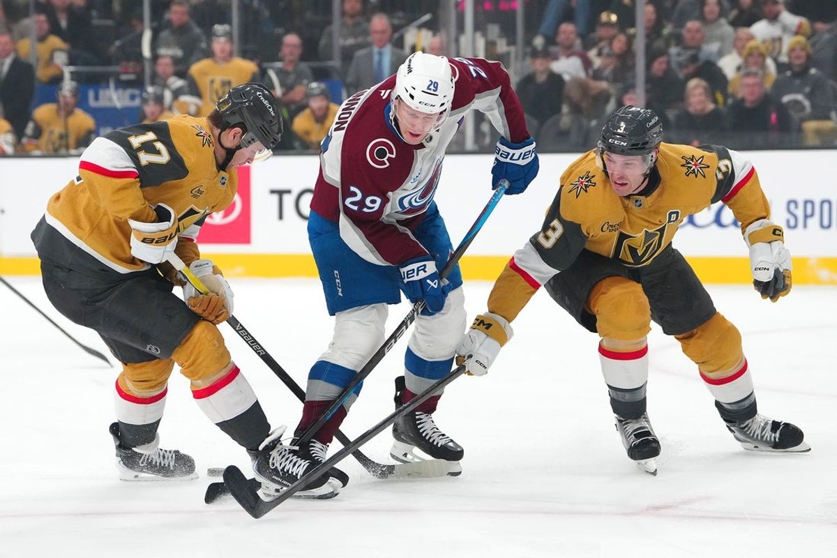 Dec 27, 2025; Las Vegas, Nevada, USA; Colorado Avalanche center Nathan MacKinnon (29) loses the puck between Vegas Golden Knights defenseman Ben Hutton (17) and defenseman Brayden McNabb (3) during the first period at T-Mobile Arena. Mandatory Credit: Stephen R. Sylvanie-Imagn Images