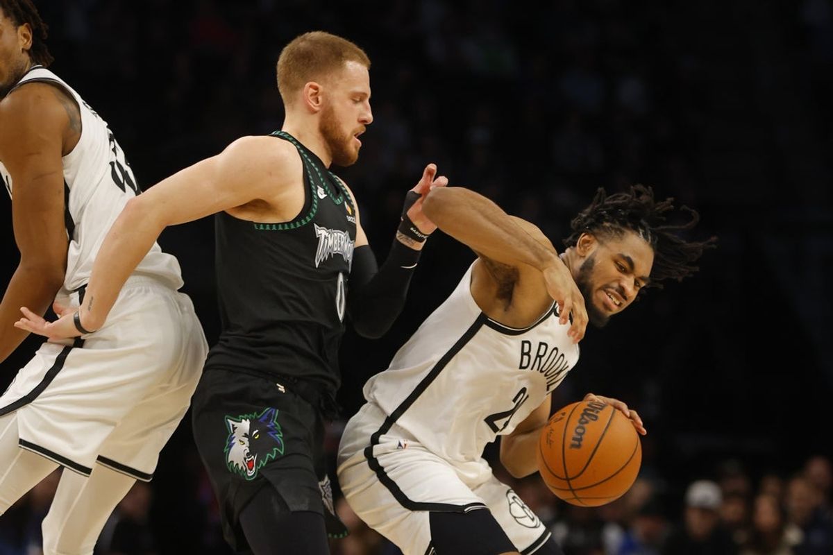 Dec 27, 2025; Minneapolis, Minnesota, USA; Brooklyn Nets guard Cam Thomas (24) works around Minnesota Timberwolves guard Donte DiVincenzo (0) in the fourth quarter at Target Center. Mandatory Credit: Bruce Kluckhohn-Imagn Images