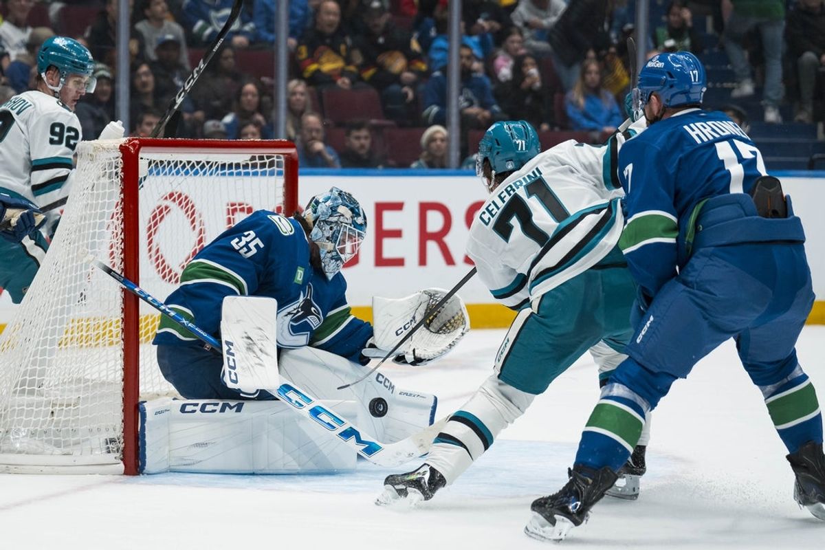 Dec 27, 2025; Vancouver, British Columbia, CAN; Vancouver Canucks defenseman Filip Hronek (17) watches as goalie Thatcher Demko (35) makes a save on San Jose Sharks forward Macklin Celebrini (71) in the first period at Rogers Arena. Mandatory Credit: Bob Frid-Imagn Images