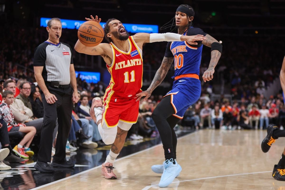 Dec 27, 2025; Atlanta, Georgia, USA; Atlanta Hawks guard Trae Young (11) is fouled by New York Knicks guard Jordan Clarkson (00) in the fourth quarter at State Farm Arena. Mandatory Credit: Brett Davis-Imagn Images