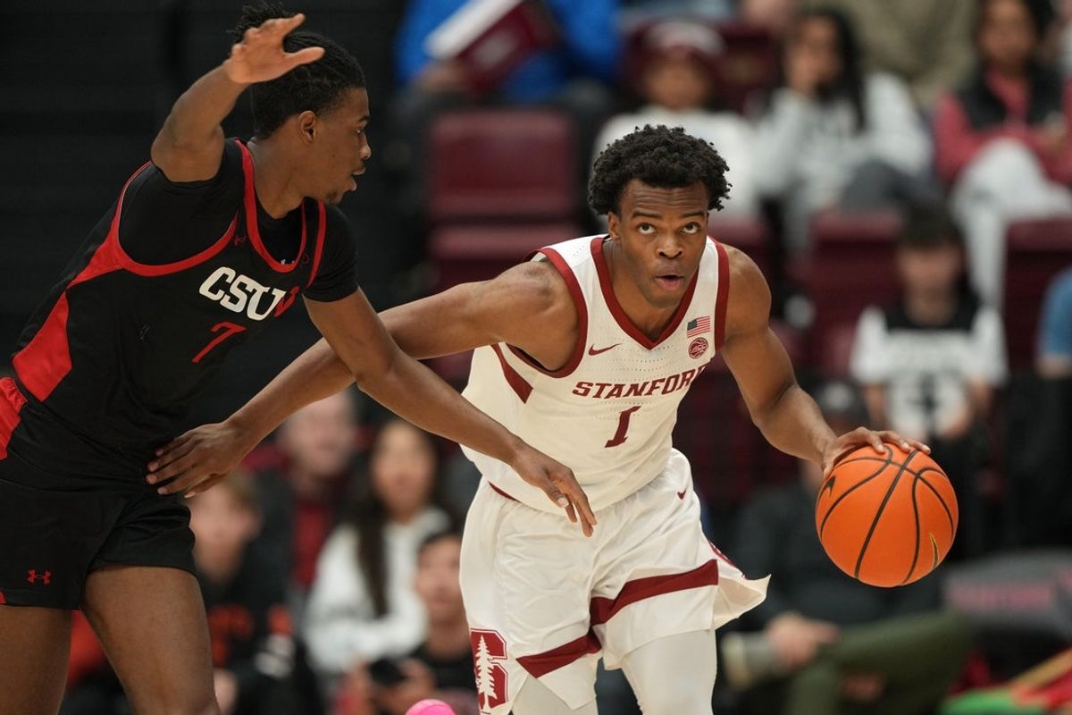 Dec 27, 2025; Stanford, California, USA; Stanford Cardinal guard Ebuka Okorie (1) dribbles against CSUN Matadors guard Joshua O'Garro (7) during the first half at Maples Pavilion. Mandatory Credit: Darren Yamashita-Imagn Images