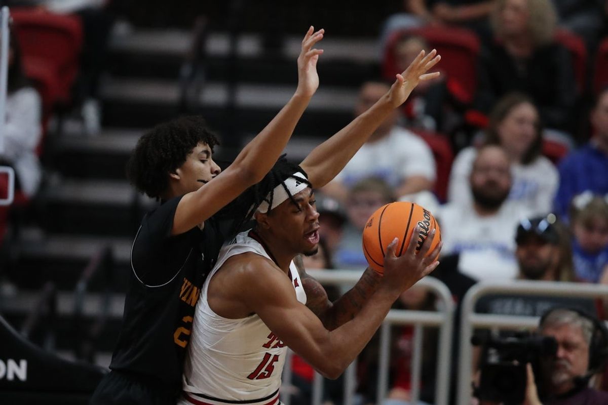 Dec 28, 2025; Lubbock, Texas, USA;  Texas Tech Red Raiders forward JT Toppin (15) works the ball against Winthrop Eagles forward Tai Hamilton (21) in the first half at United Supermarkets Arena. Mandatory Credit: Michael C. Johnson-Imagn Images