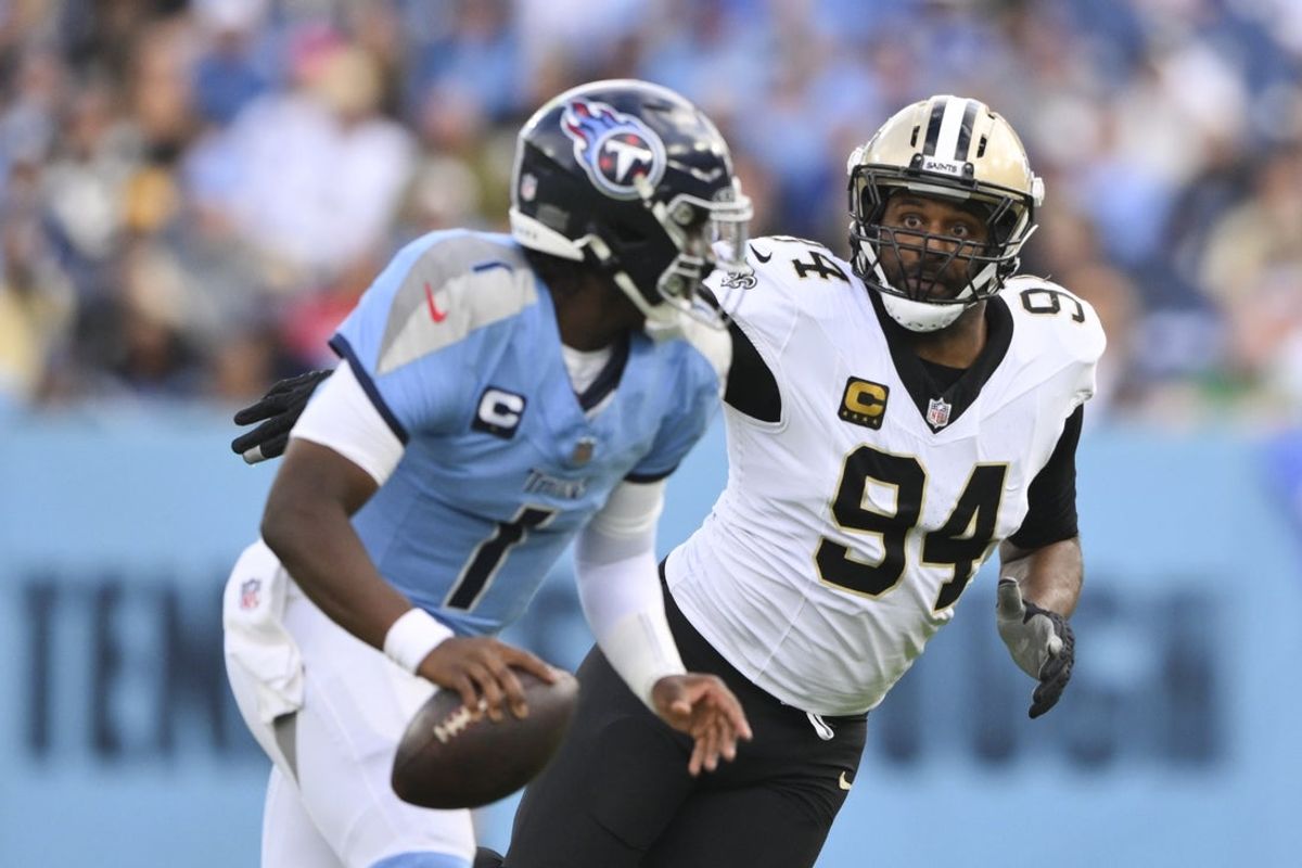Dec 28, 2025; Nashville, Tennessee, USA;  New Orleans Saints defensive end Cameron Jordan (94) gives chase to Tennessee Titans quarterback Cam Ward (1) during the second half of the game at Nissan Stadium. Mandatory Credit: Steve Roberts-Imagn Images