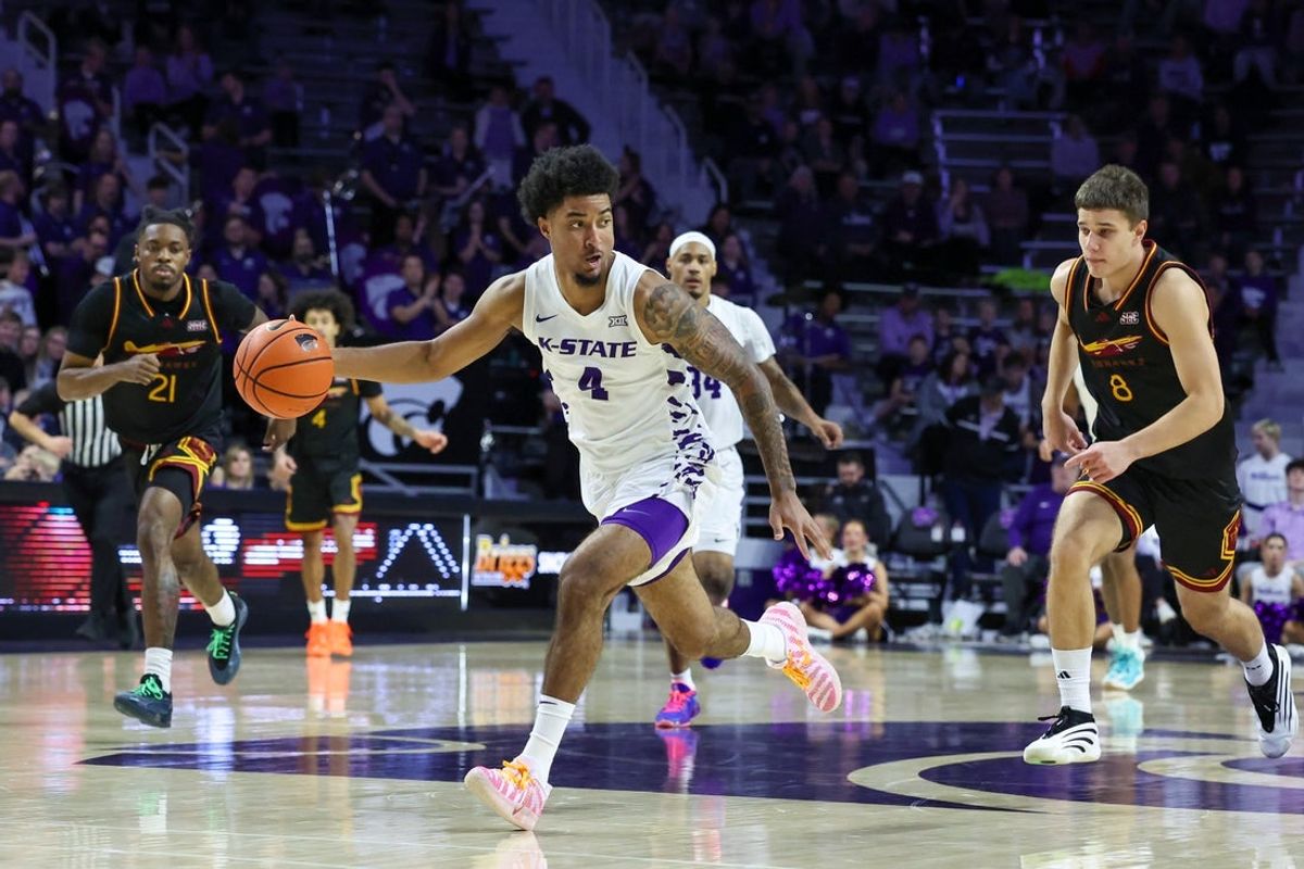 Dec 28, 2025; Manhattan, Kansas, USA; Kansas State Wildcats guard P.J. Haggerty (4) dribbles by Louisiana-Monroe Warhawks guards3 Alex Molofeev (8) and MJ Russell (21) during the second half at Bramlage Coliseum. Mandatory Credit: Scott Sewell-Imagn Images