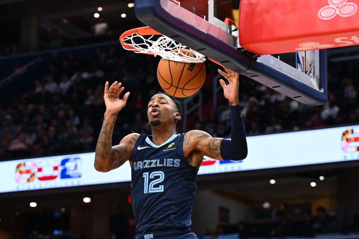 Dec 28, 2025; Washington, District of Columbia, USA; Memphis Grizzlies guard Ja Morant (12) dunks the ball against the Washington Wizards during the first half at Capital One Arena. Mandatory Credit: Brad Mills-Imagn Images