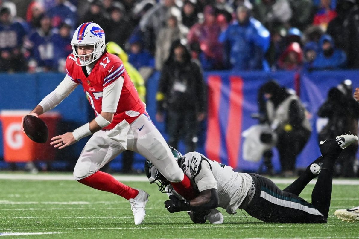 Dec 28, 2025; Orchard Park, New York, USA; Philadelphia Eagles linebacker Jaelan Phillips (50) tackles Buffalo Bills quarterback Josh Allen (17) during the first quarter at Highmark Stadium. Mandatory Credit: Mark Konezny-Imagn Images