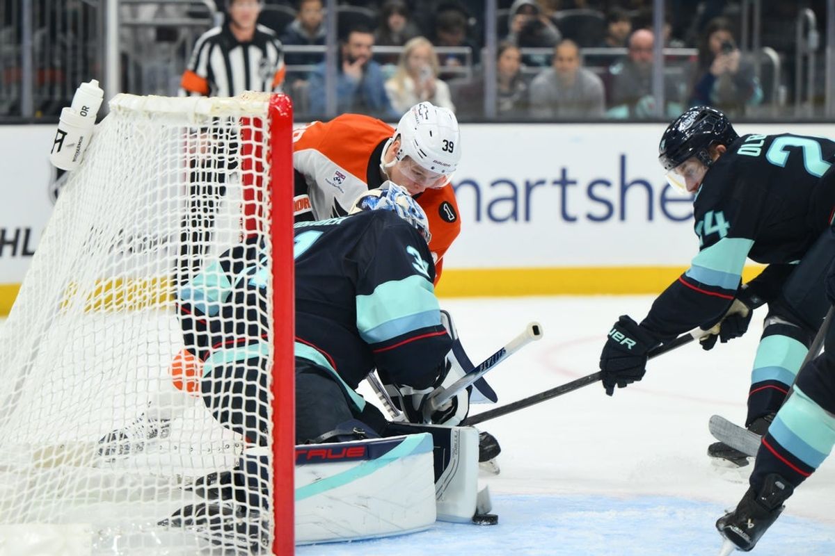 Dec 28, 2025; Seattle, Washington, USA; Seattle Kraken goaltender Philipp Grubauer (31) blocks a goal shot by Philadelphia Flyers right wing Matvei Michkov (39) during the first period at Climate Pledge Arena. Mandatory Credit: Steven Bisig-Imagn Images