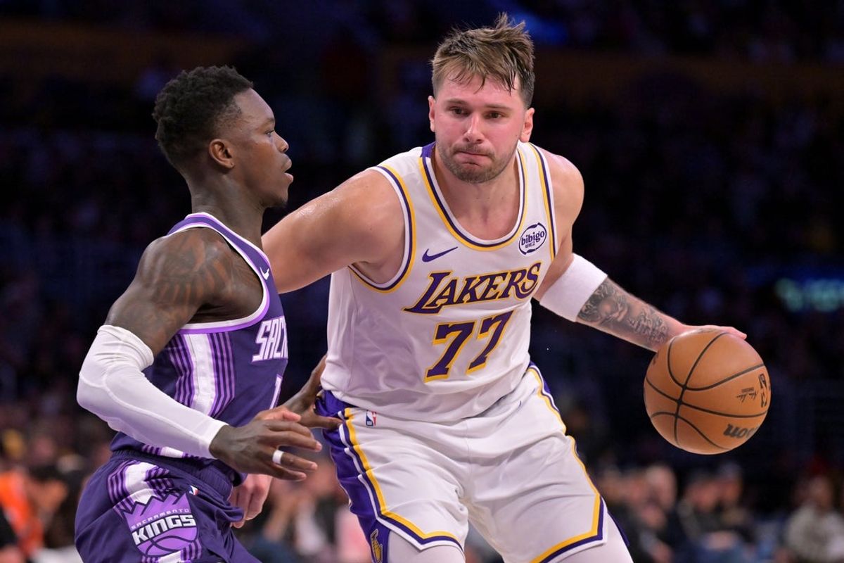 Dec 28, 2025; Los Angeles, California, USA;  Sacramento Kings guard Dennis Schroder (17) defemds Los Angeles Lakers guard Luka Doncic (77) in the second half at Crypto.com Arena. Mandatory Credit: Jayne Kamin-Oncea-Imagn Images