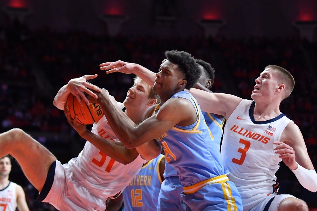 Dec 29, 2025; Champaign, Illinois, USA;  Illinois Fighting Illini center Jason Jakstys (31) Southern University Jaguars forward Ashton Magee (24) and Illinois Fighting Illini forward Ben Humrichhous (3) battle for a rebound Iduring the second half at State Farm Center. Mandatory Credit: Ron Johnson-Imagn Images