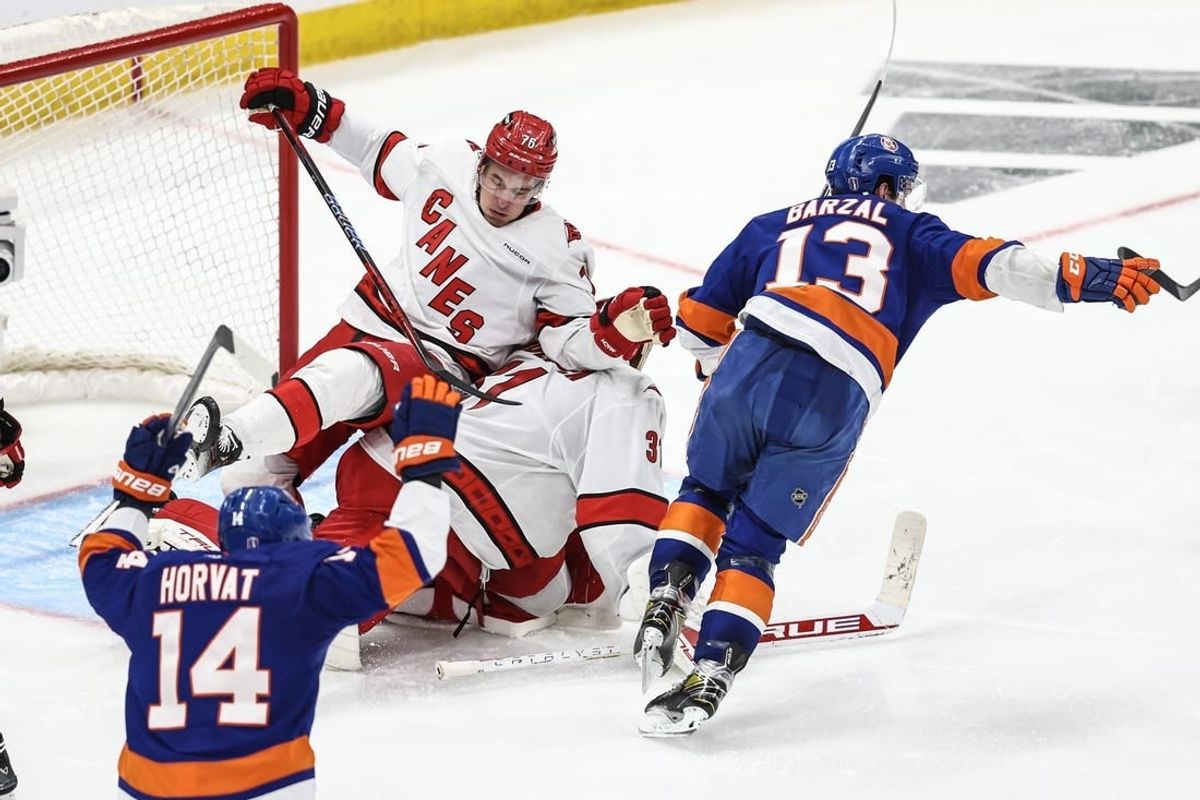 Apr 27, 2024; Elmont, New York, USA; New York Islanders center Mathew Barzal (13) skates towards his teammates after scoring the game winning goal in the second overtime against the Carolina Hurricanes in game four of the first round of the 2024 Stanley Cup Playoffs at UBS Arena.