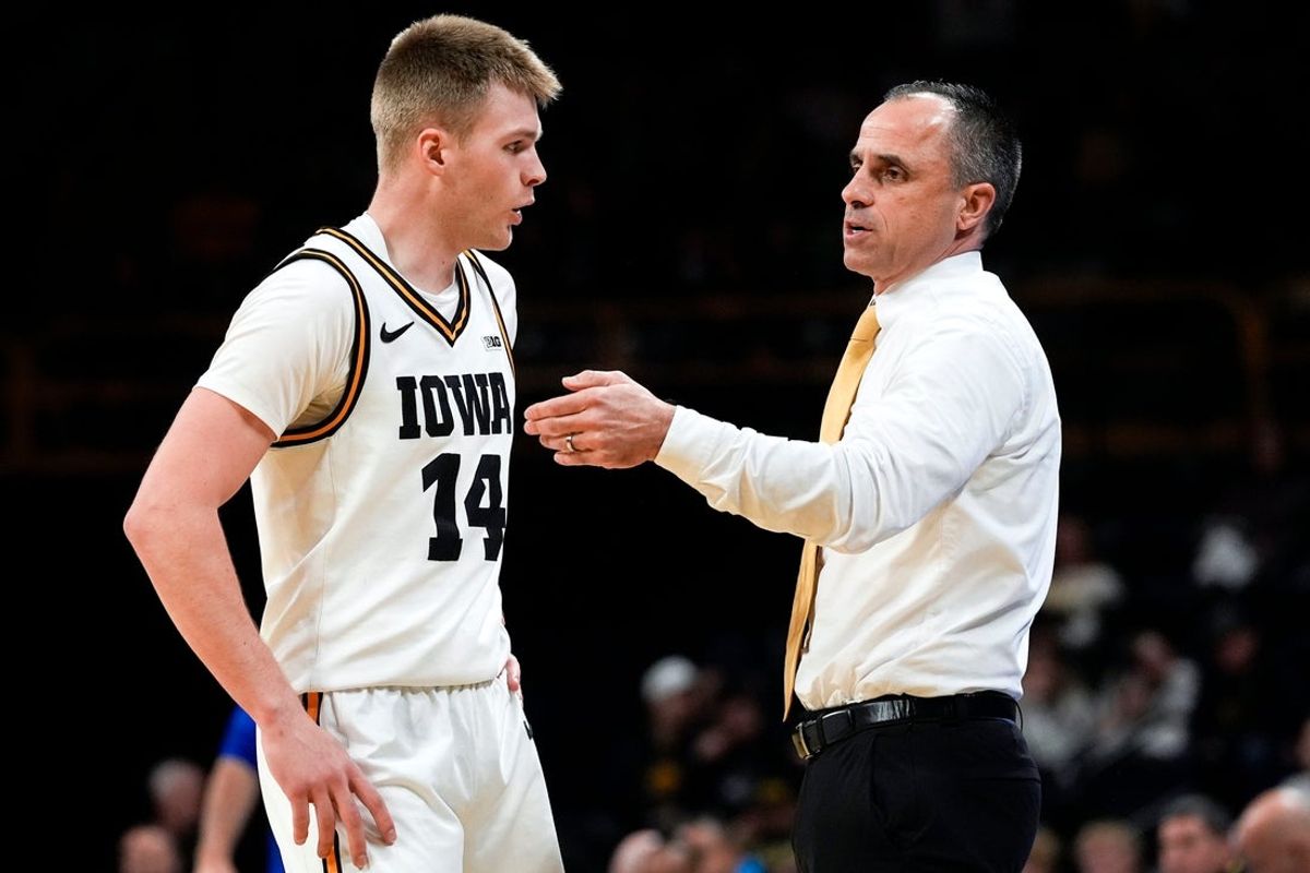 Iowa guard Bennett Stirtz (14) talks to Iowa head coach Ben McCollum during a game against the UMass Lowell Riverhawks Dec. 29, 2025 at Carver-Hawkeye Arena in Iowa City, Iowa.