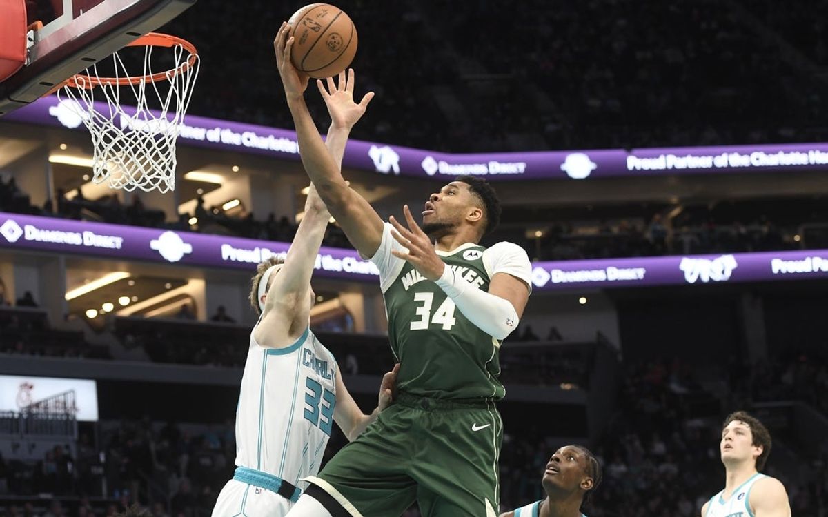 Dec 29, 2025; Charlotte, North Carolina, USA;  Milwaukee Bucks forward Giannis Antetokounmpo (34) drives in past Charlotte Hornets forward Liam McNeeley (33) during the first half at the Spectrum Center. Mandatory Credit: Sam Sharpe-Imagn Images