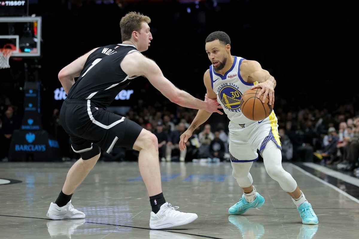 Dec 29, 2025; Brooklyn, New York, USA; Golden State Warriors guard Stephen Curry (30) controls the ball against Brooklyn Nets forward Danny Wolf (2) during the second quarter at Barclays Center. Mandatory Credit: Brad Penner-Imagn Images