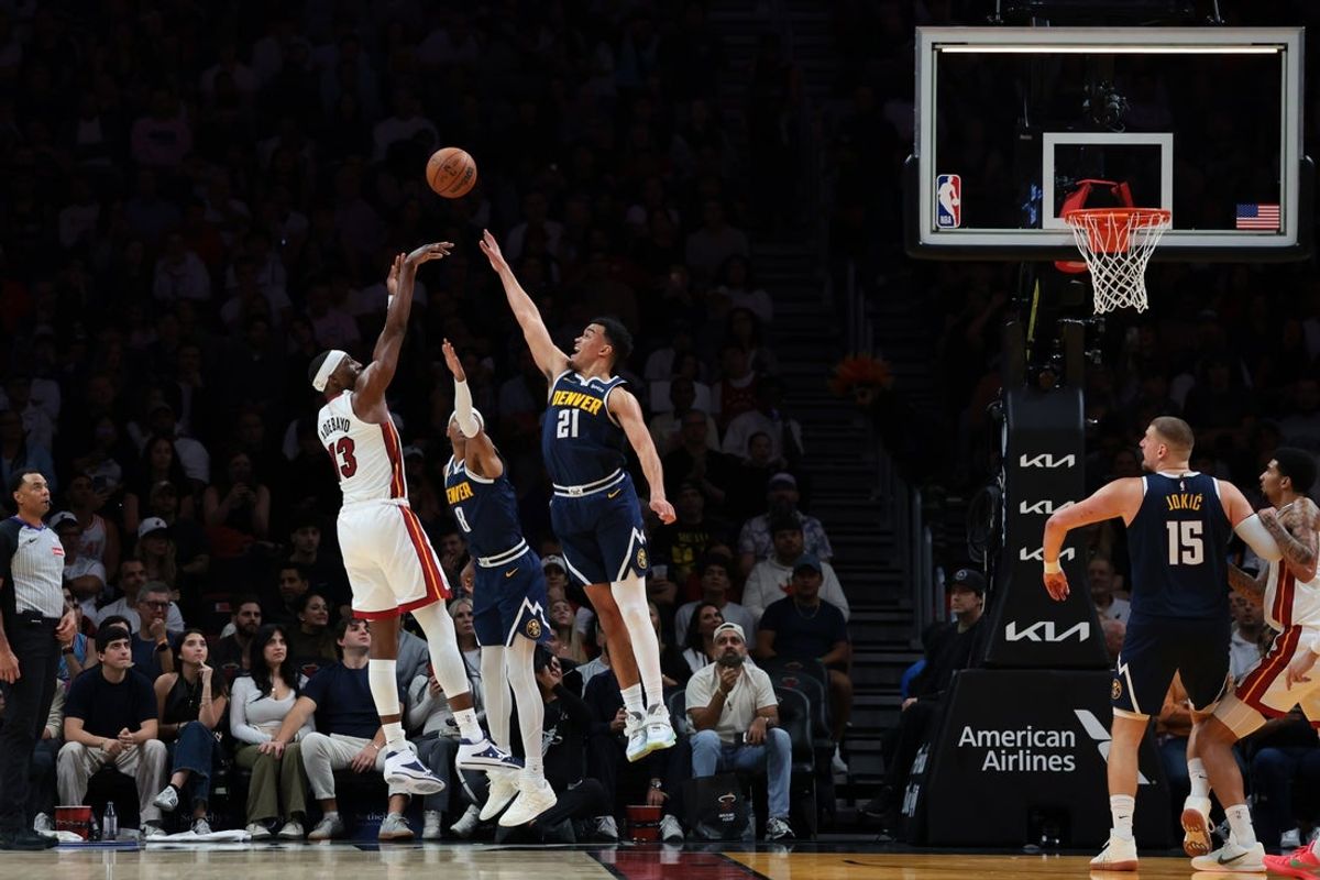 Dec 29, 2025; Miami, Florida, USA; Miami Heat center Bam Adebayo (13) shoots the basketball over Denver Nuggets forward Spencer Jones (21) and guard Peyton Watson (8) during the second quarter at Kaseya Center. Mandatory Credit: Sam Navarro-Imagn Images