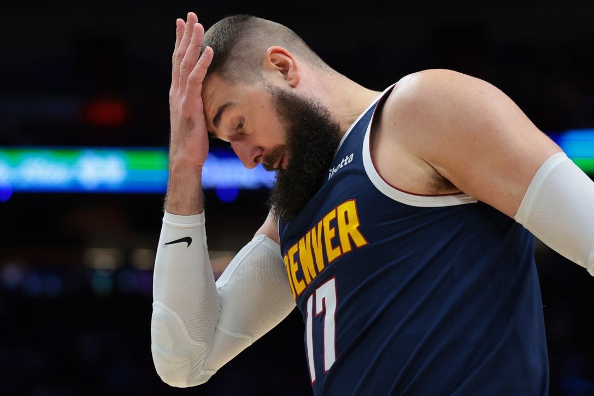Dec 29, 2025; Miami, Florida, USA; Denver Nuggets center Jonas Valanciunas (17) covers his forehead with his hand after driving to the basket against the Miami Heat during the second quarter at Kaseya Center. Mandatory Credit: Sam Navarro-Imagn Images