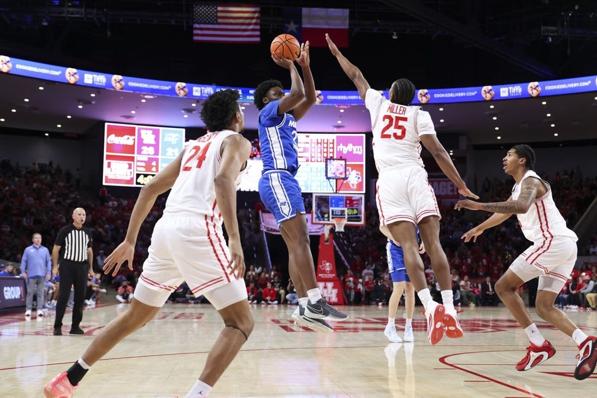 Dec 29, 2025; Houston, Texas, USA; Middle Tennessee Blue Raiders guard Kamari Lands (22) shoots the ball as Houston Cougars guard Mercy Miller (25) defends during the first half at Fertitta Center. Mandatory Credit: Troy Taormina-Imagn Images