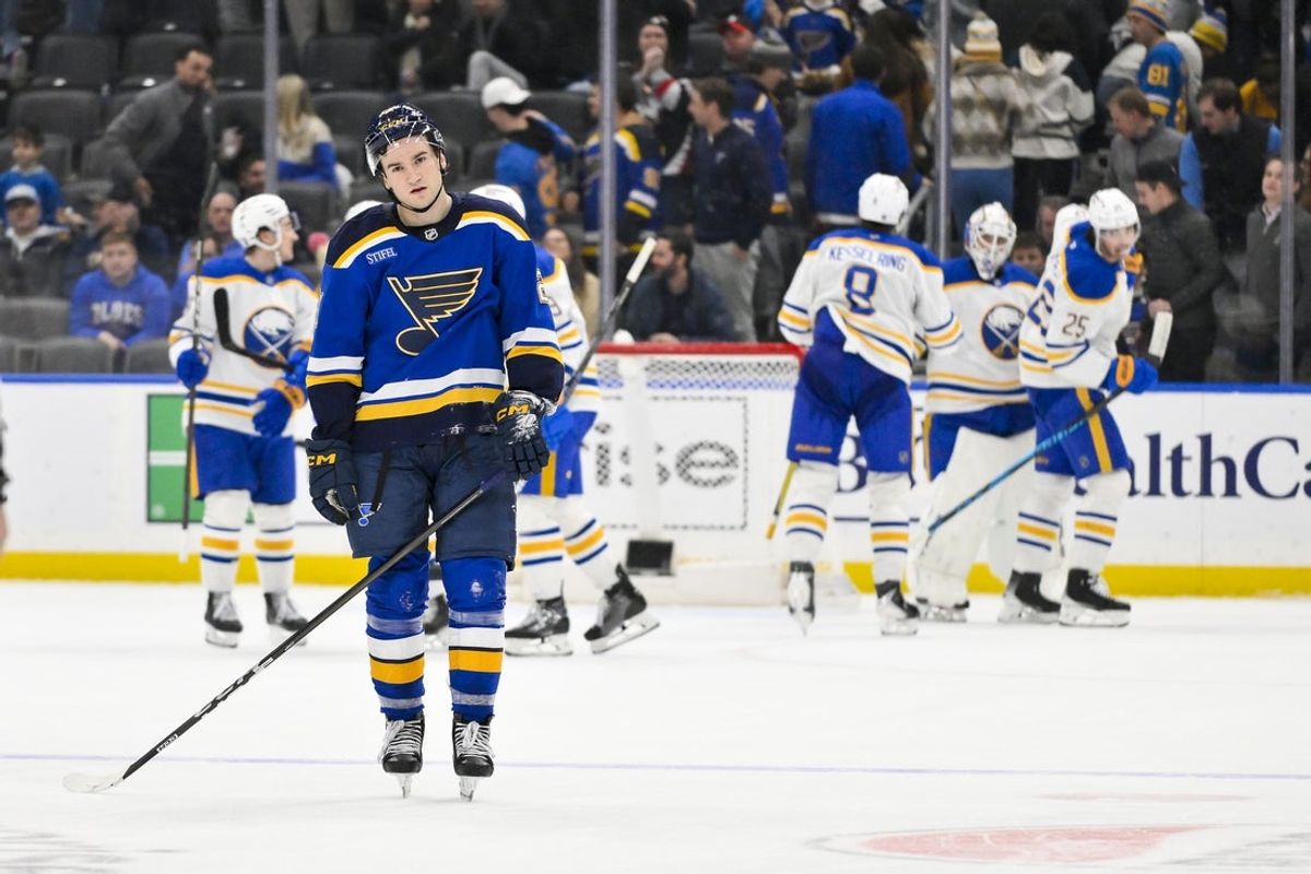 Dec 29, 2025; St. Louis, Missouri, USA; St. Louis Blues right wing Jimmy Snuggerud (21) looks on after Buffalo Sabres center Peyton Krebs (not pictured) scored an empty net goal during the third period at Enterprise Center. Mandatory Credit: Jeff Curry-Imagn Images