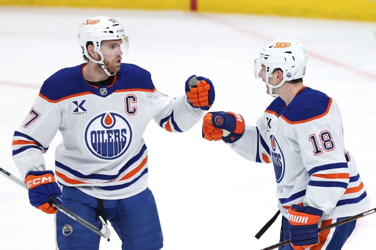 Dec 29, 2025; Winnipeg, Manitoba, CAN; Edmonton Oilers left wing Zach Hyman (18) celebrates an empty net goal against the Winnipeg Jets with Edmonton Oilers center Connor McDavid (97) in the third period at Canada Life Centre. Mandatory Credit: James Carey Lauder-Imagn Images