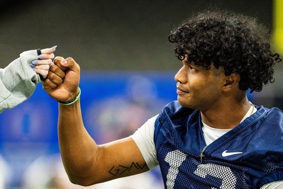 Ole Miss quarterback Austin Simmons (13) fist bumps a manager during an Ole Miss practice for the Sugar Bowl and College Football Playoff quarterfinals at Caesars Superdome in New Orleans, La., on Tuesday, Dec. 30, 2025.