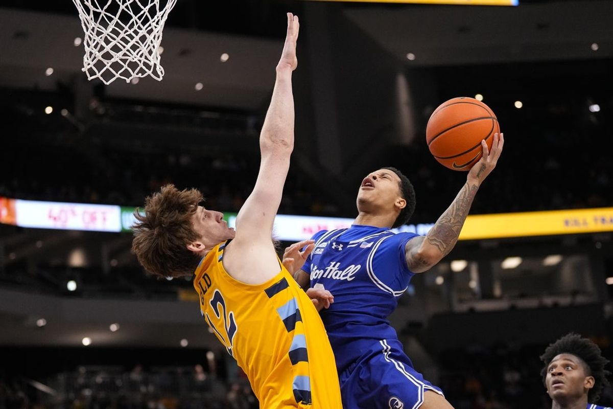 Dec 30, 2025; Milwaukee, Wisconsin, USA;  Seton Hall Pirates guard Adam Clark (0) shoots against Marquette Golden Eagles forward Ben Gold (12) during the first half at Fiserv Forum. Mandatory Credit: Jeff Hanisch-Imagn Images