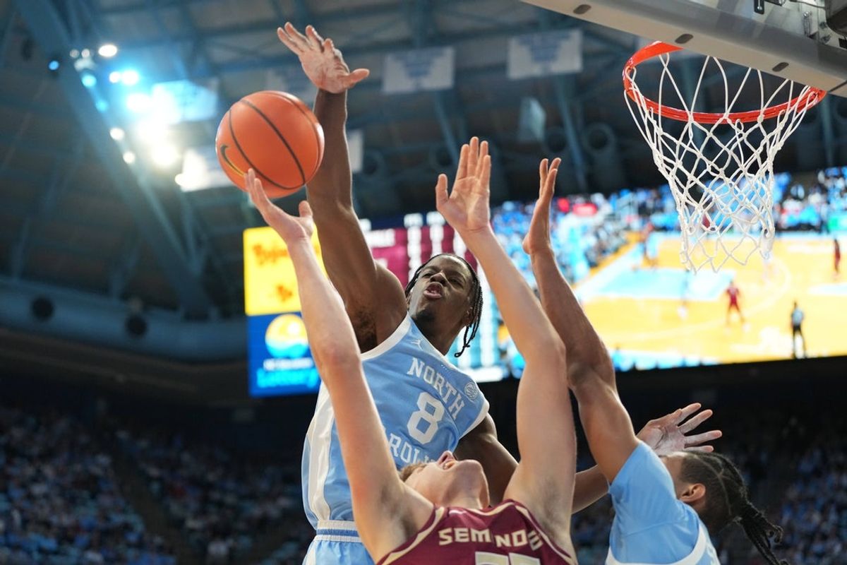 Dec 30, 2025; Chapel Hill, North Carolina, USA; North Carolina Tar Heels forward Caleb Wilson (8) blocks the shot of Florida State Seminoles forward Alex Steen (25) as North Carolina Tar Heels forward Jarin Stevenson (15) helps defend in the first half at Dean E. Smith Center. Mandatory Credit: Bob Donnan-Imagn Images