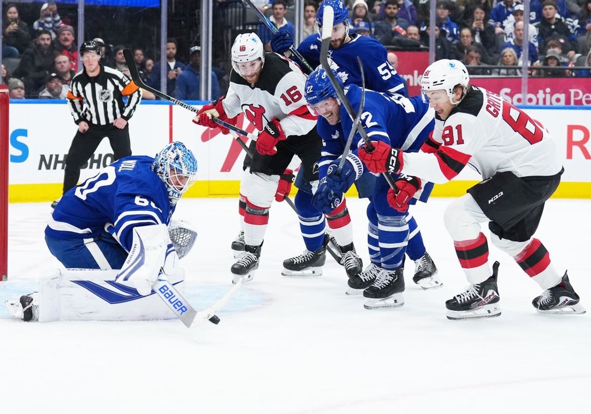 Dec 30, 2025; Toronto, Ontario, CAN; Toronto Maple Leafs defenseman Jake McCabe (22) battles for the puck with New Jersey Devils right wing Arseny Gritsyuk (81) during the second period at Scotiabank Arena. Mandatory Credit: Nick Turchiaro-Imagn Images
