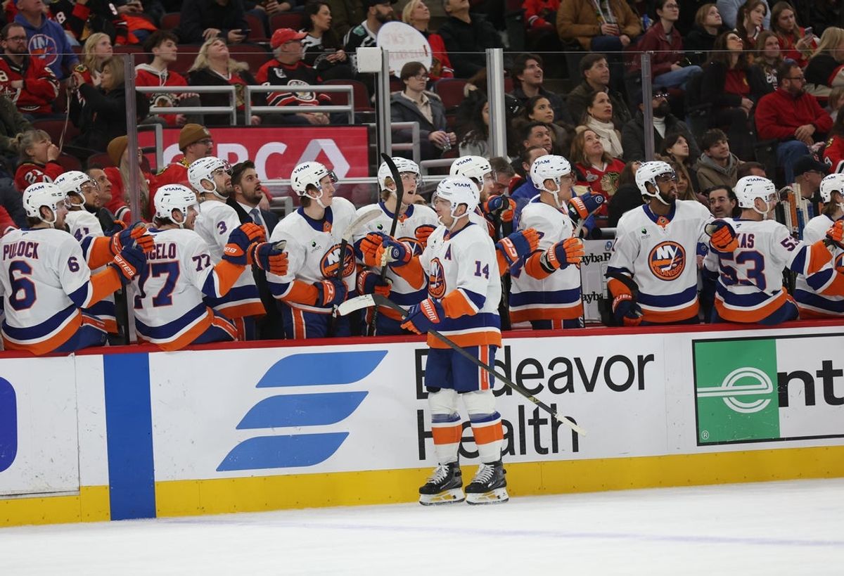 Dec 30, 2025; Chicago, Illinois, USA; New York Islanders center Bo Horvat (14) high-fives teammates on the bench while celebrating a first-period goal against the Chicago Blackhawks at United Center. Mandatory Credit: Talia Sprague-Imagn Images