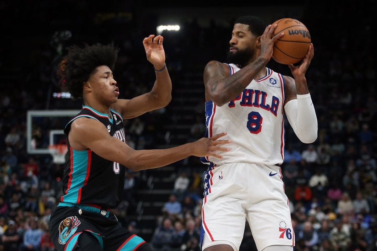 Dec 30, 2025; Memphis, Tennessee, USA; Philadelphia 76ers forward Paul George (8) handles the ball as Memphis Grizzlies forward Jaylen Wells (0) defends during the second quarter at FedExForum. Mandatory Credit: Petre Thomas-Imagn Images